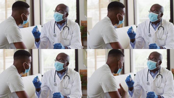 非裔美国资深男医生戴着口罩在家给男患者注射新冠疫苗
