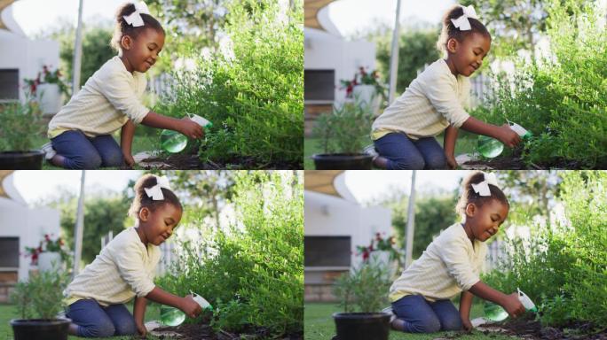 快乐的非洲裔美国女孩园艺，浇灌花园中的植物