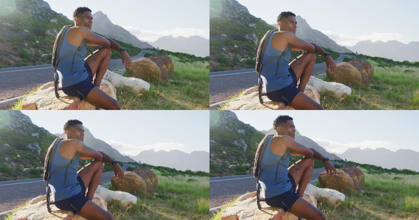 非洲裔美国人越野跑坐在岩石上在山区乡村