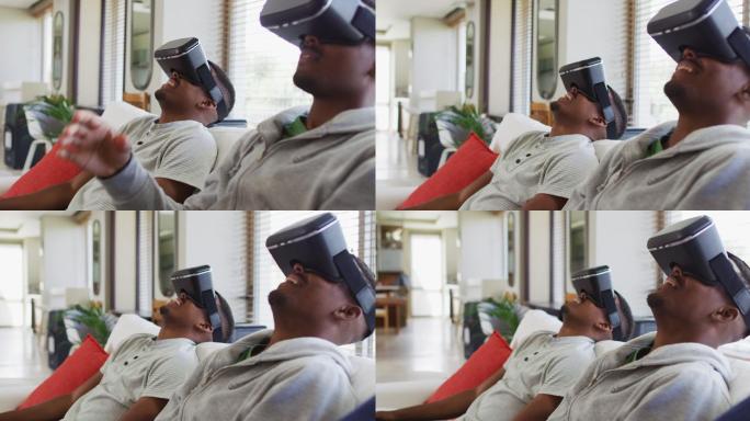两个非洲裔美国青少年双胞胎兄弟坐在沙发上，戴着虚拟现实头盔微笑