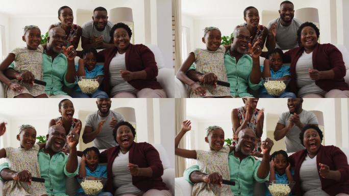非裔美国家庭三代人一起在家里看电视时一起欢呼