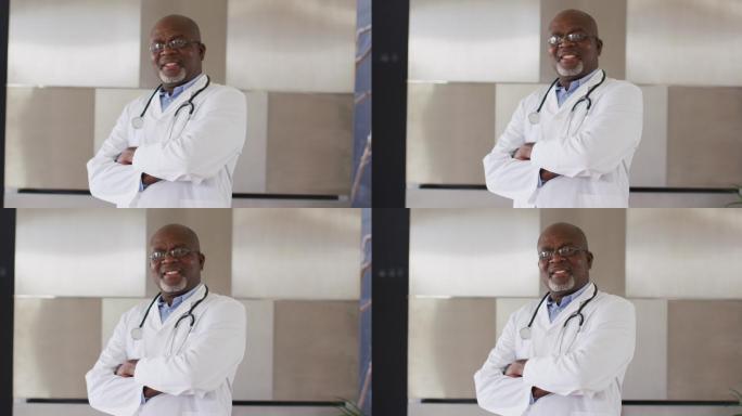 身着白衣，面带微笑的非裔美国资深男医生交叉双臂望着镜头