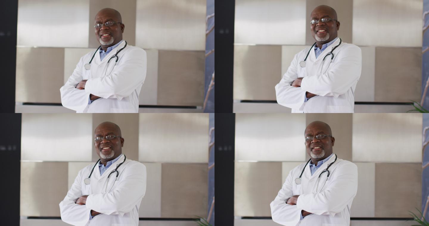 身着白衣，面带微笑的非裔美国资深男医生交叉双臂望着镜头