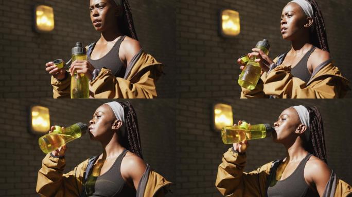 非裔美国妇女在户外运动，饮用水在城市