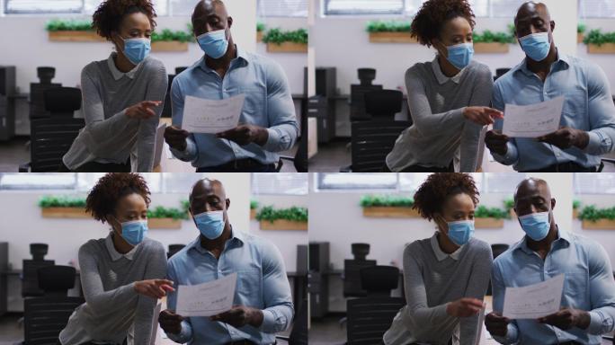不同的男女业务同事戴着口罩交谈，男子手持文件在办公室