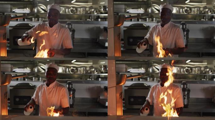 非裔美国男厨师在餐厅厨房用平底锅煎