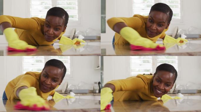 快乐的非洲裔美国女性在厨房清洁台面