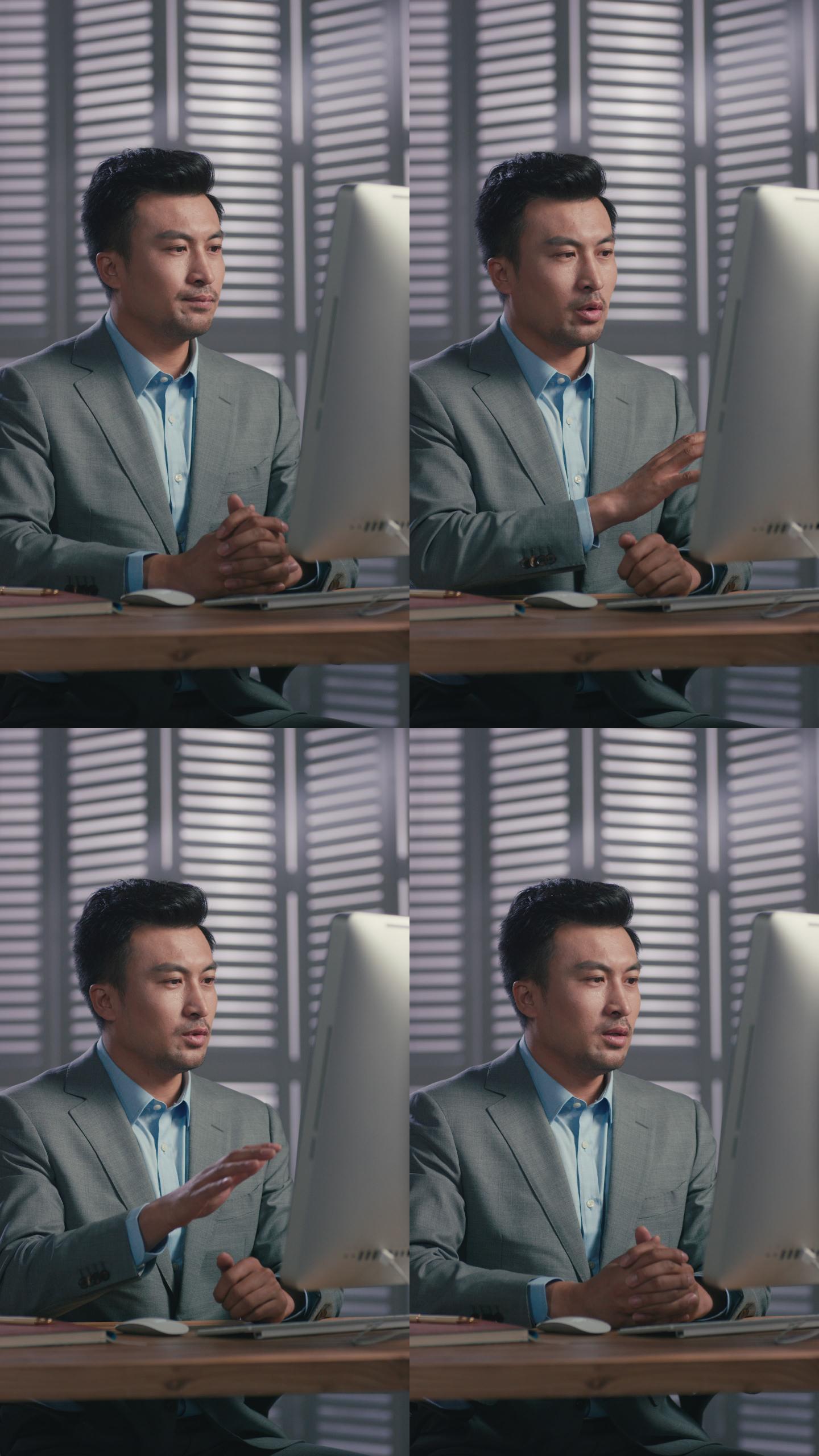商务男士在办公室用电脑视频