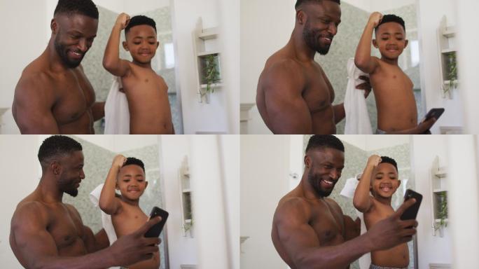 非裔美国父亲和儿子在镜子前展示他们的肌肉，一起自拍