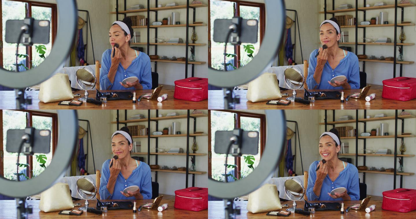 混血女视频博主在家化妆并在智能手机上录音