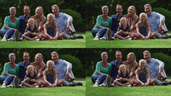 微笑的白人父母，祖父母和孙子坐在花园里微笑的肖像