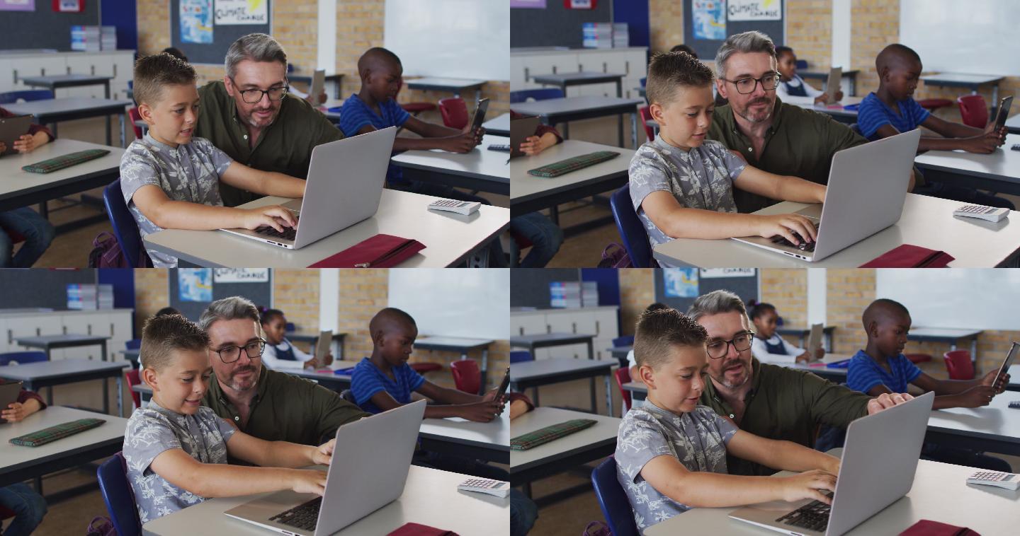 不同的男老师帮助一个坐在教室里使用笔记本电脑的男孩