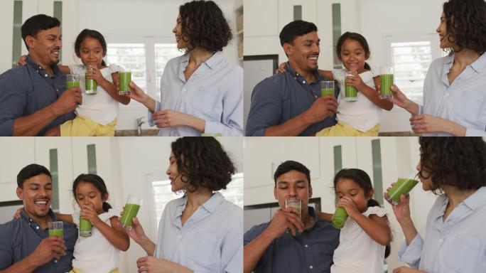 幸福的西班牙家庭，女儿喝绿色奶昔