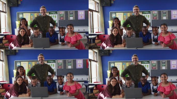 快乐的不同男老师和一群孩子看着笔记本电脑的肖像