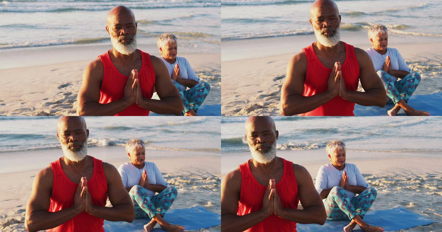 一对非洲裔美国夫妇在海滩上练习瑜伽