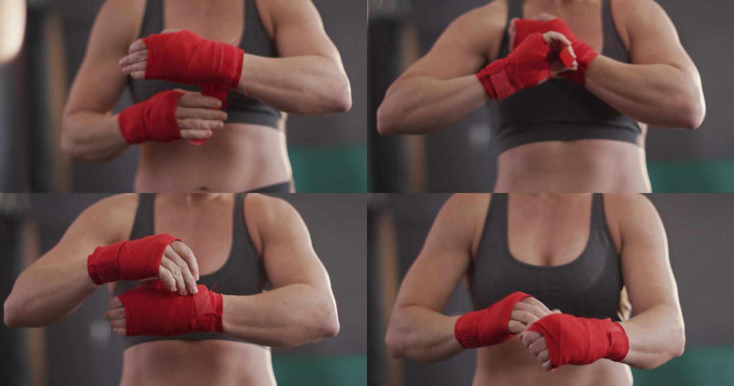 在体育馆里，白种女拳击手的中段缠在手上的拳击胶带