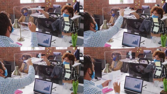 不同的商务同事戴着口罩在喷嚏屏幕上交换文件