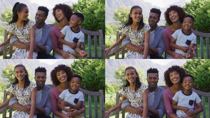 快乐的非裔美国父母，女儿和儿子坐在户外的长凳上