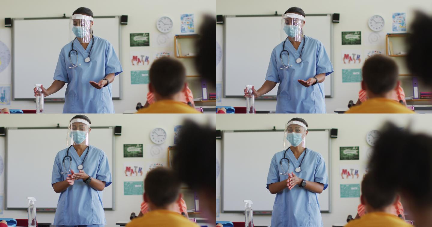戴着口罩的女医务人员向学童示范如何消毒双手