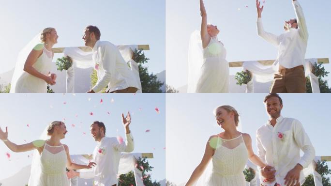 幸福的白人新婚夫妇，在户外的圣坛前跳跃抛掷花瓣