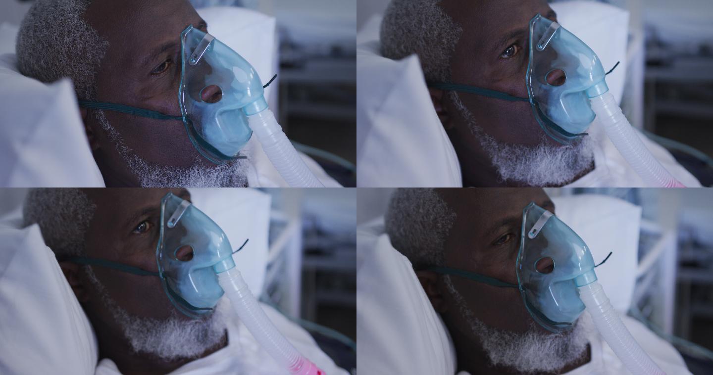 非裔美国男性病人在医院病床上戴着氧气面罩