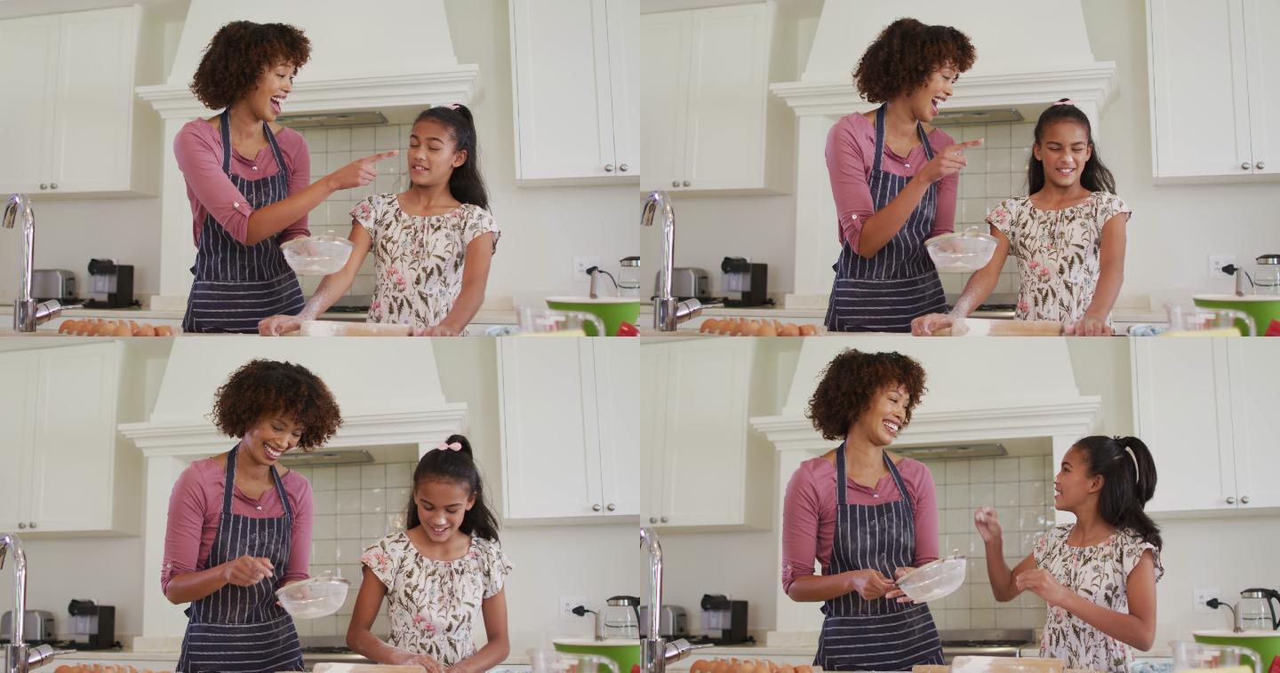 非裔美国母亲和女儿在家里的厨房里一起烘焙