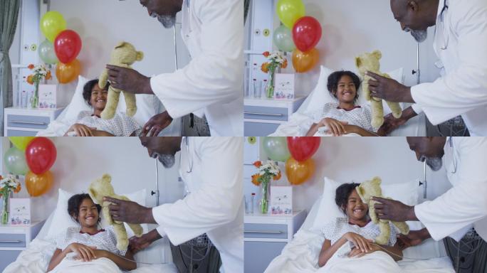 在医院病床上，男医生带着指尖脉搏血氧仪和女孩玩泰迪熊