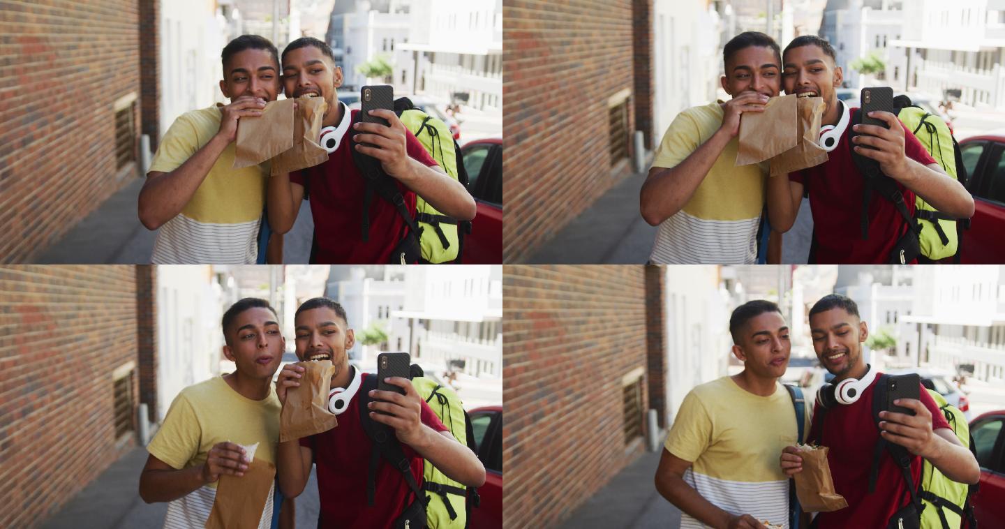 两个快乐的混血朋友在街上一边吃一边自拍