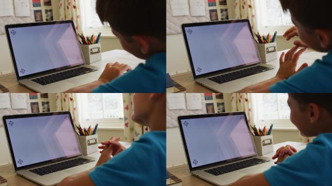 一个白人男孩在家里用笔记本电脑打视频电话