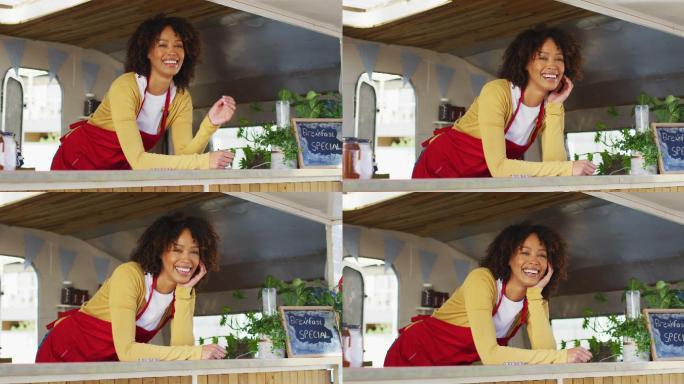 非裔美国妇女穿着围裙站在餐车里微笑的肖像
