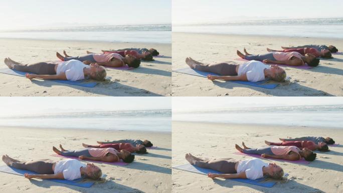 一群不同的女性朋友在沙滩上练习瑜伽，躺在垫子上