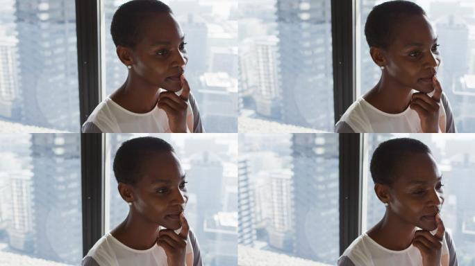 非裔美国女商人在窗口思考的肖像