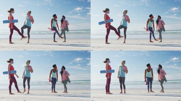 一群戴着口罩、拿着瑜伽垫在沙滩上的女性朋友