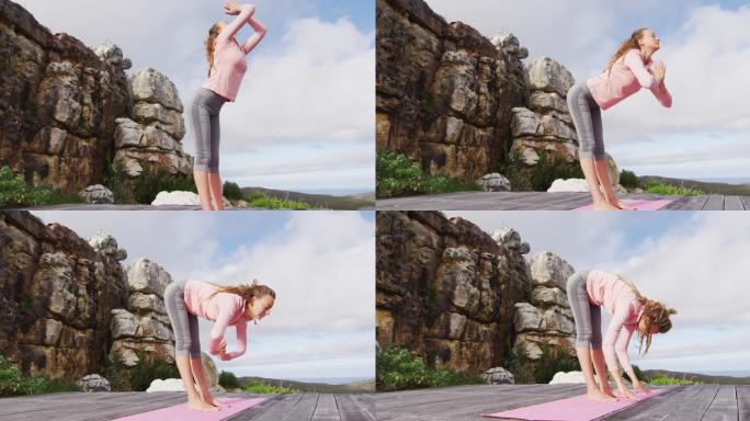 白人女性，站在山坡上练习瑜伽，伸展身体，触摸地板