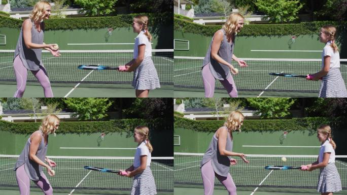 一个白人母亲在一个阳光明媚的日子在教她的女儿打网球