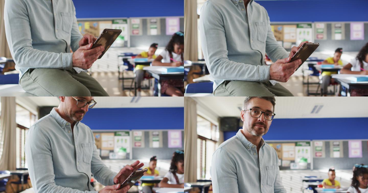 快乐的白人男教师在教室里，孩子们用平板电脑看着相机