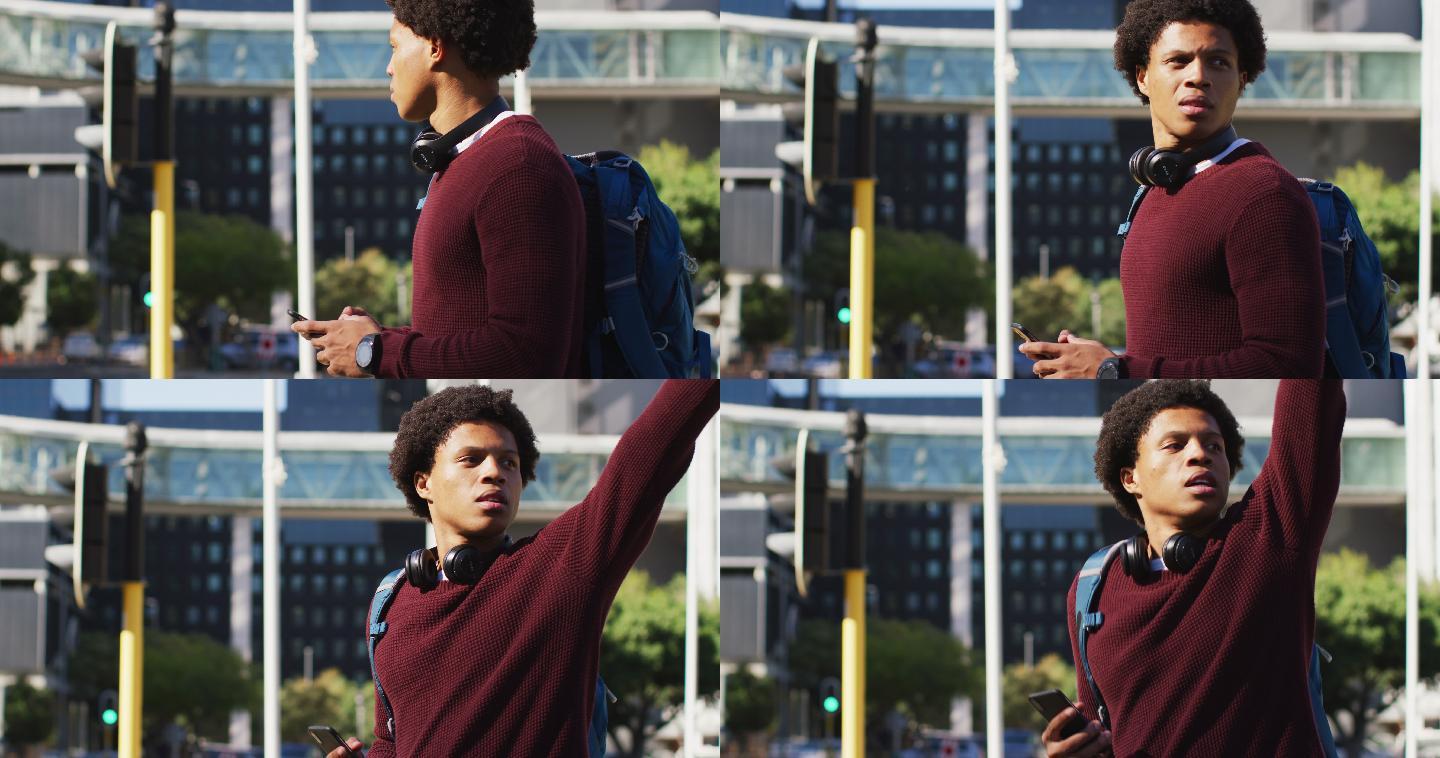 非洲裔美国人在城市使用智能手机，戴着耳机和背包在街上叫出租车