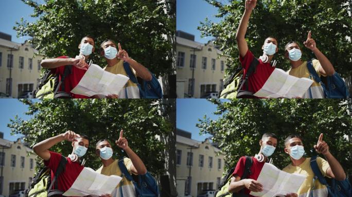 两个混血男性朋友戴着口罩在街上使用地图