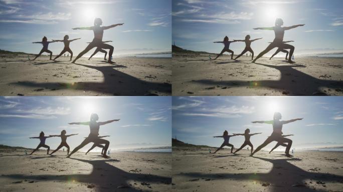 一群不同类型的女性朋友在沙滩上练习瑜伽