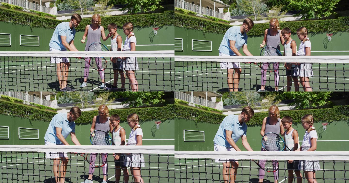 白种人的父母在一个阳光明媚的日子在网球场教他们的孩子打网球