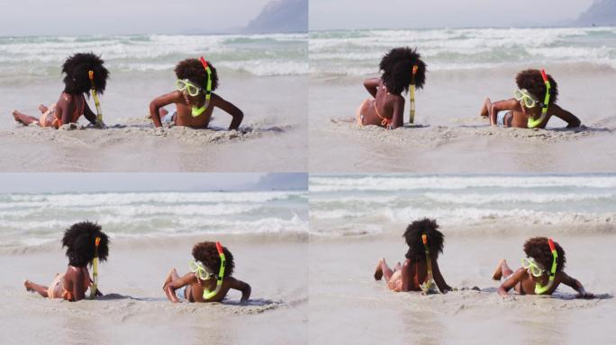 非裔美国儿童戴着潜水镜在海滩上玩耍