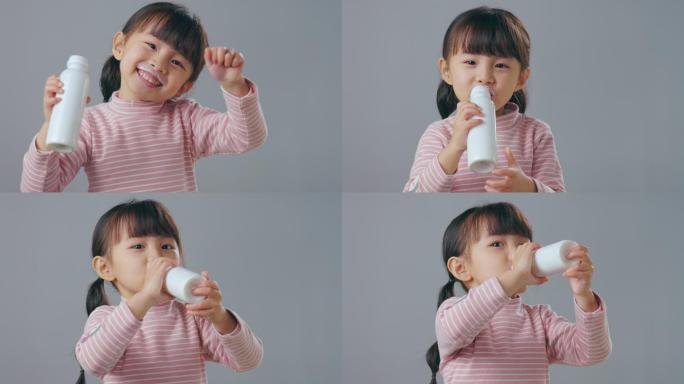 喝牛奶的小女孩