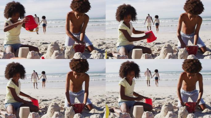 非洲裔美国兄妹在沙滩上玩沙子