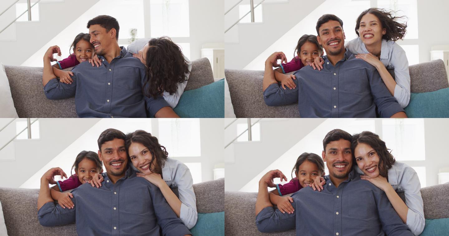 幸福的西班牙父母和女儿在客厅拥抱