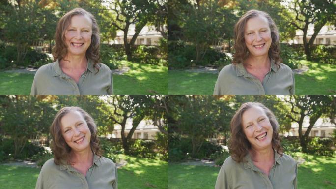 快乐的高级白人妇女肖像站在花园微笑