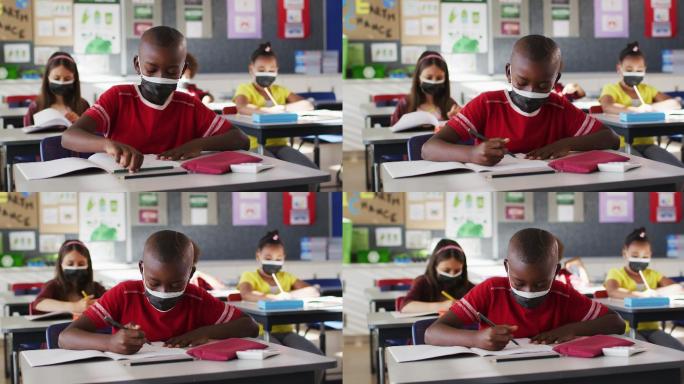 非裔美国男孩在学校上课时戴着口罩