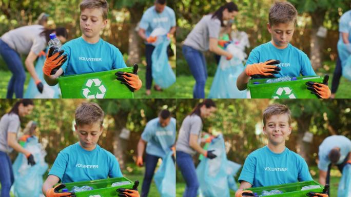 微笑的白种人儿子在户外拿着回收箱，和父母一起收集塑料垃圾
