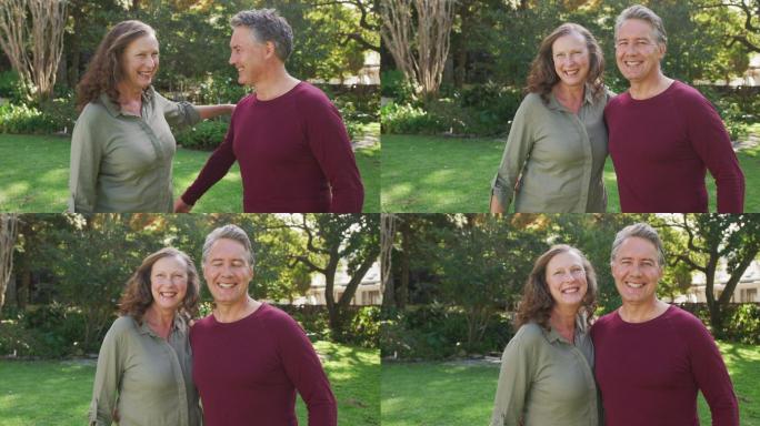 快乐的老年白人夫妇站在花园拥抱和微笑的肖像