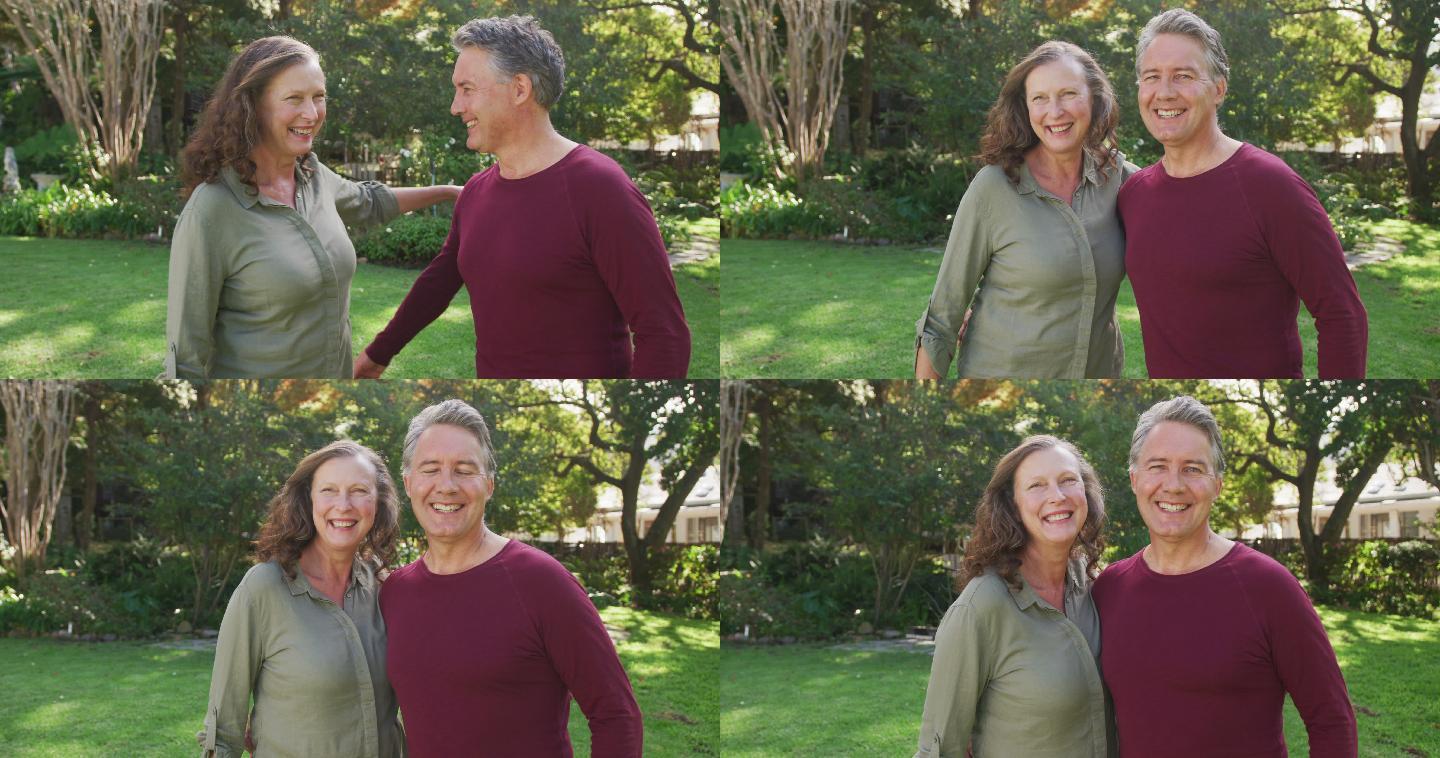 快乐的老年白人夫妇站在花园拥抱和微笑的肖像
