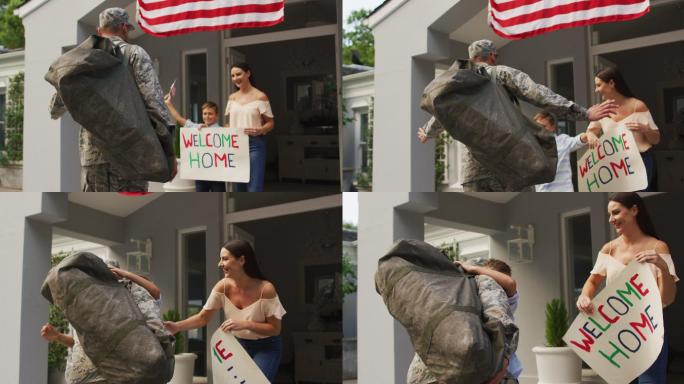 快乐的白种人男性士兵欢迎儿子和妻子在他们的房子外面签欢迎回家